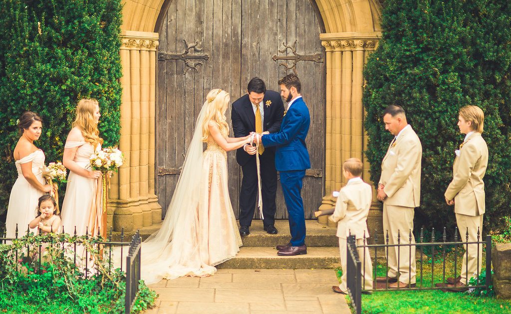 Wedding Photograph Of Bride and Groom Holding Hands in Front of Pastor Los Angeles