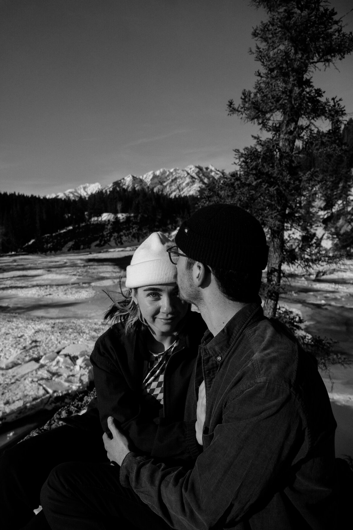 black and white image man kissing woman's forehead