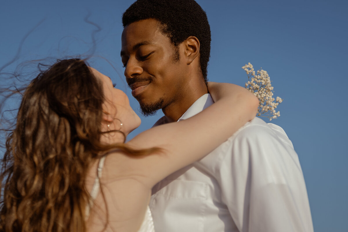 A loving shot of a couple gazing into each other’s eyes, radiating affection at White Rock Lake in Dallas.