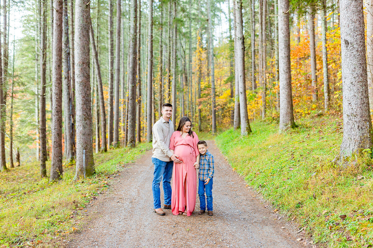 Family-of-three poses outdoors in the woods of South Carolina by Tiffany McFalls Photography.