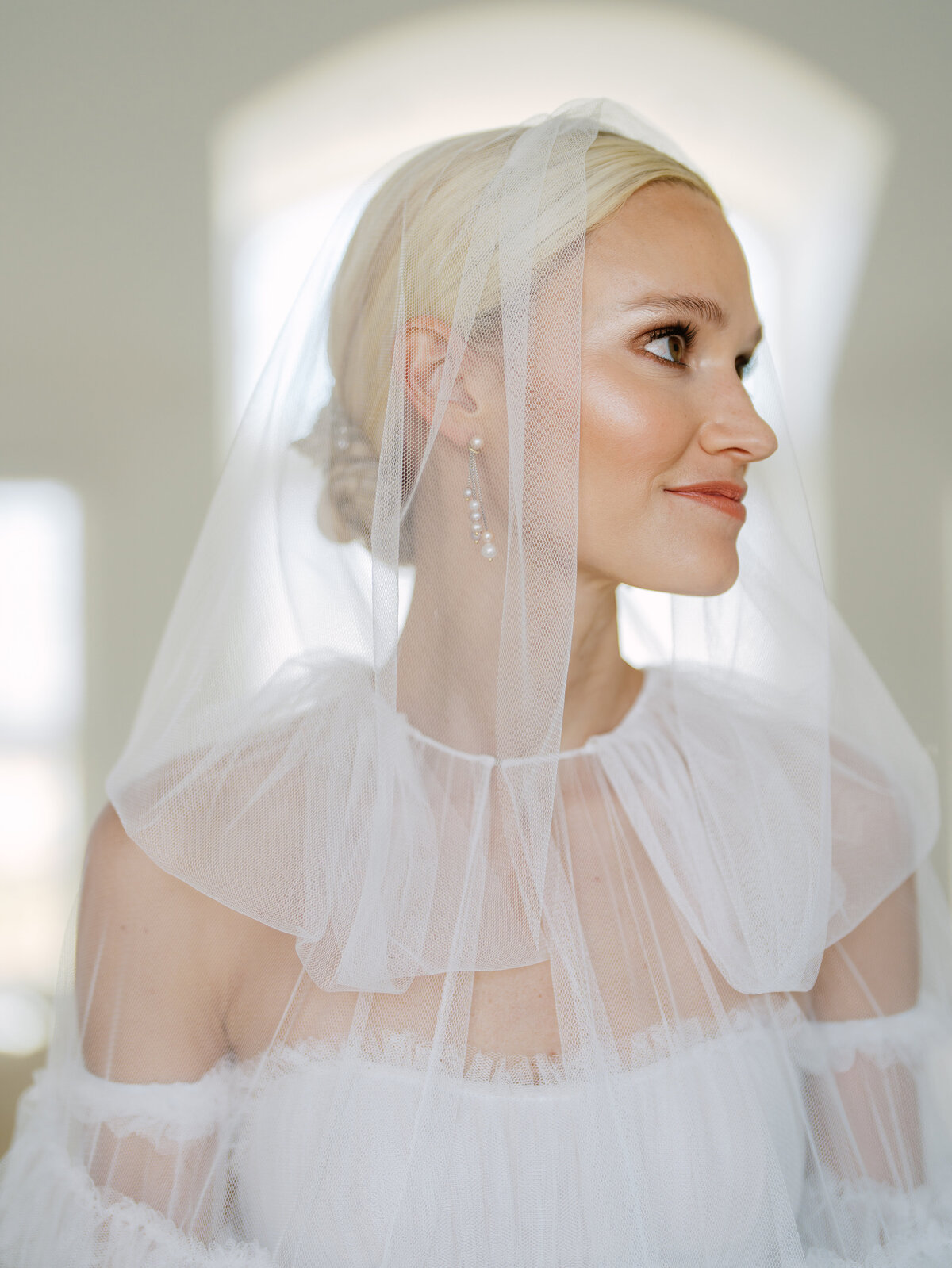 beautiful bride Madeleine with gorgeous highlights and a soft tulle hood on her wedding day