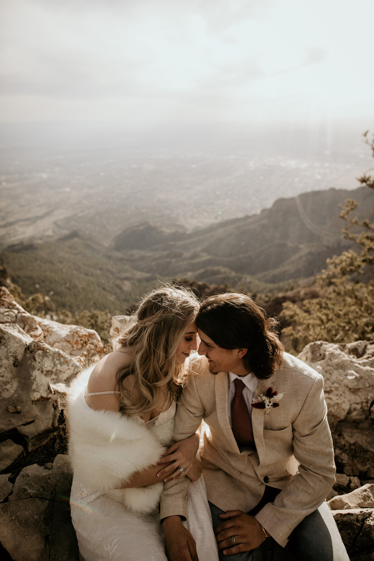 bride and groom sitting together at Sandia Peak in Albuquerque