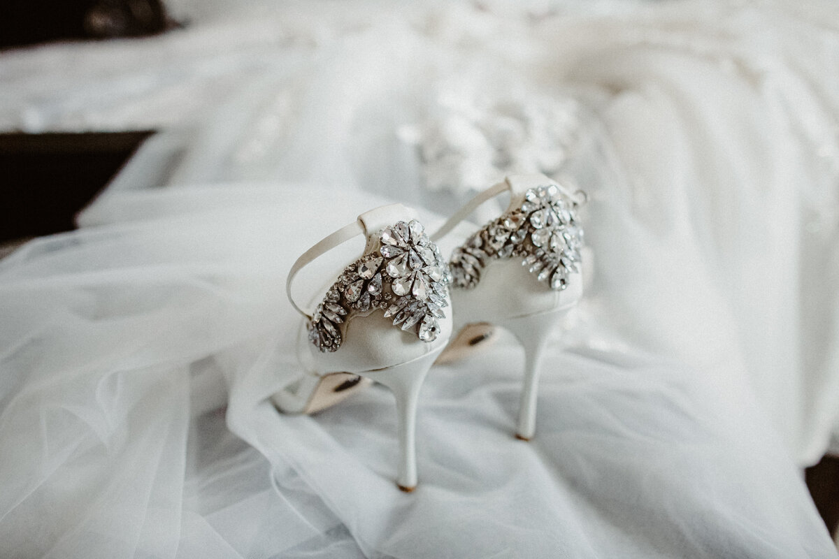 detail image of wedding shoes adorned with crystals on a veil