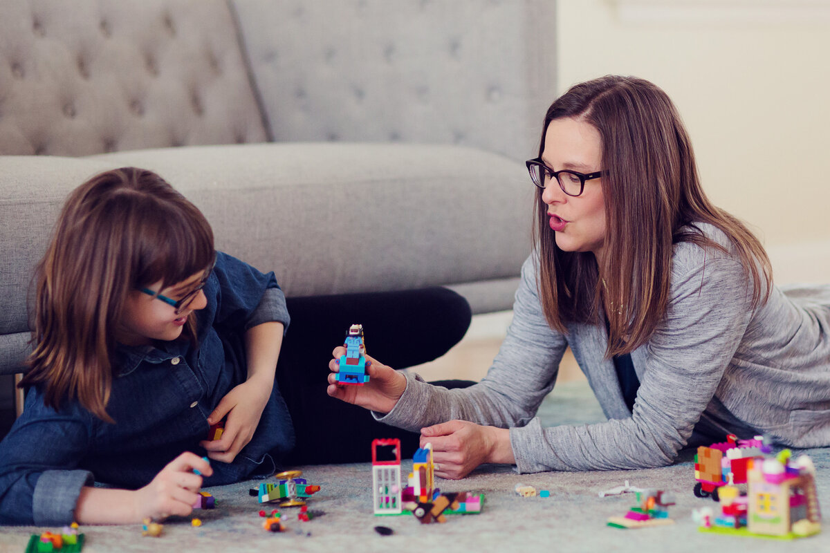 Playtime on the floor with some legos for Mom and her daughter.