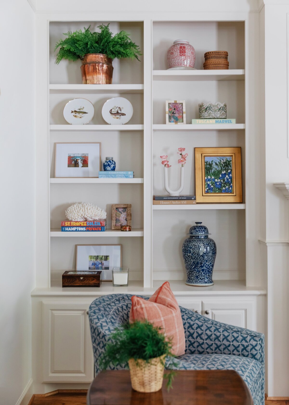 oyster creek studios oak forest remodel  white shelving with plants artwork and vase in living room