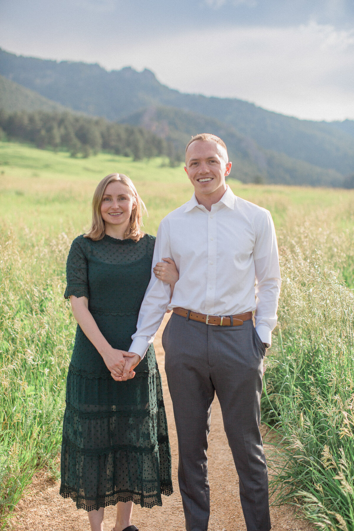 The joyfully engaged couple smile for the camera with Gregory Canyon in the background