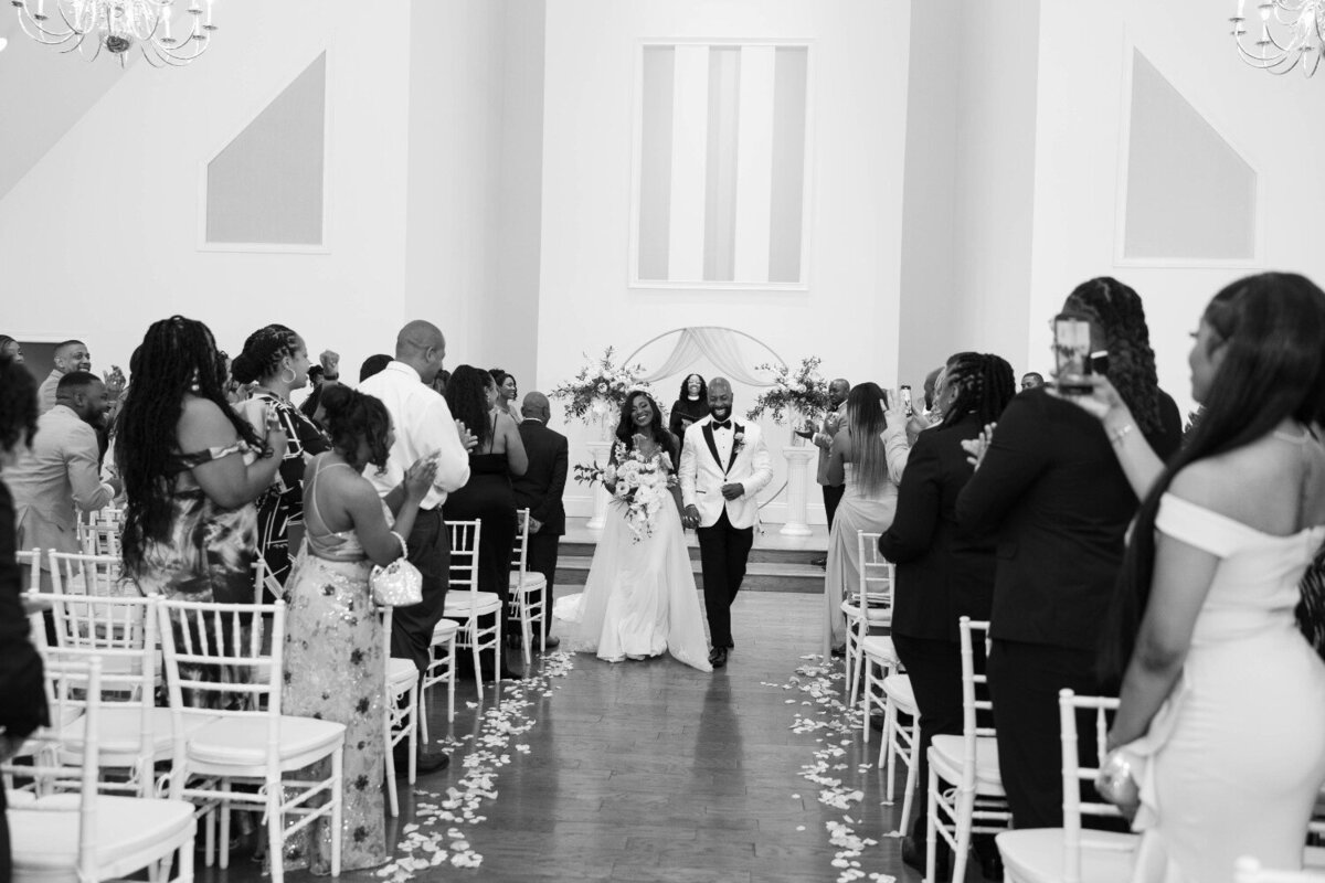 bride-groom-walking-down-aisle-black-white-ritz-charles