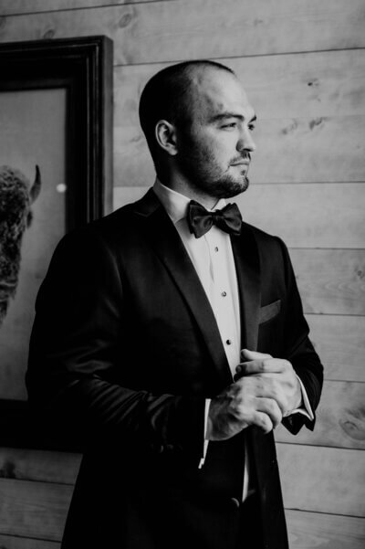 Groom buttoning jacket planned by luxury wedding planner chicago