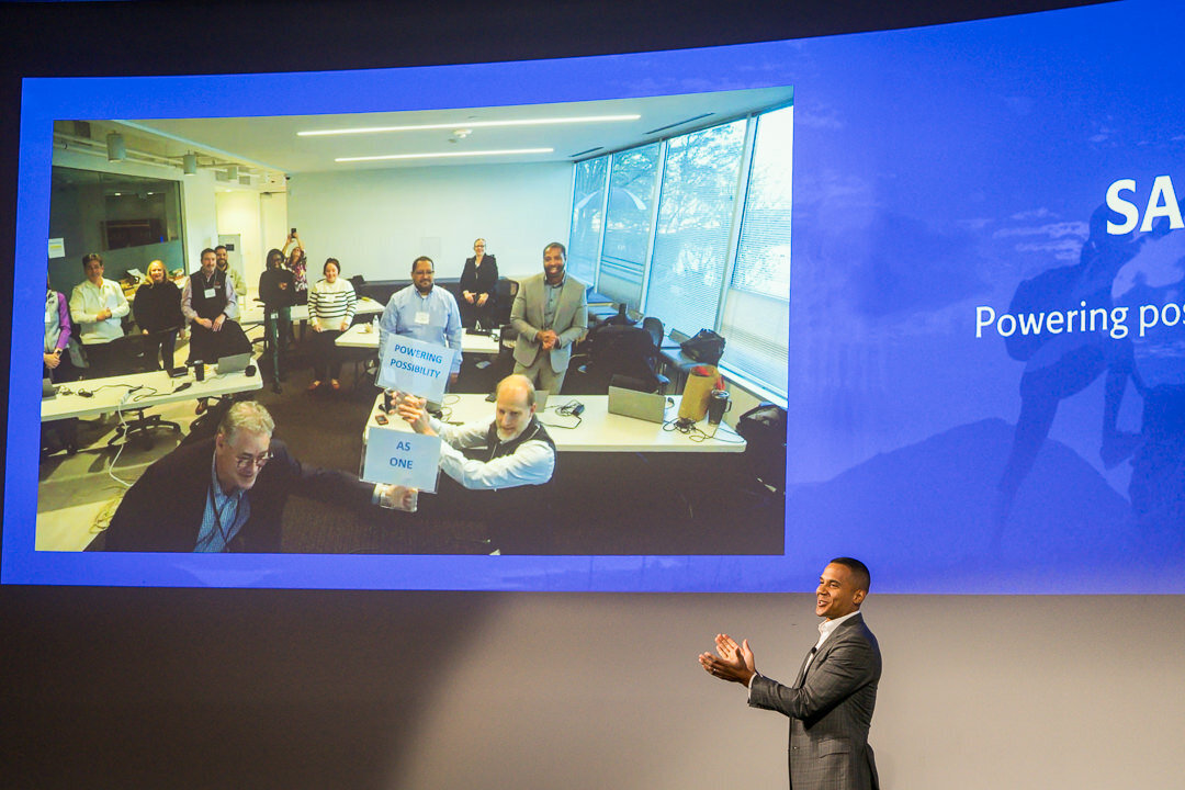 Corporate event photography of presenter with large projection screen delivering keynote talk new jersey.