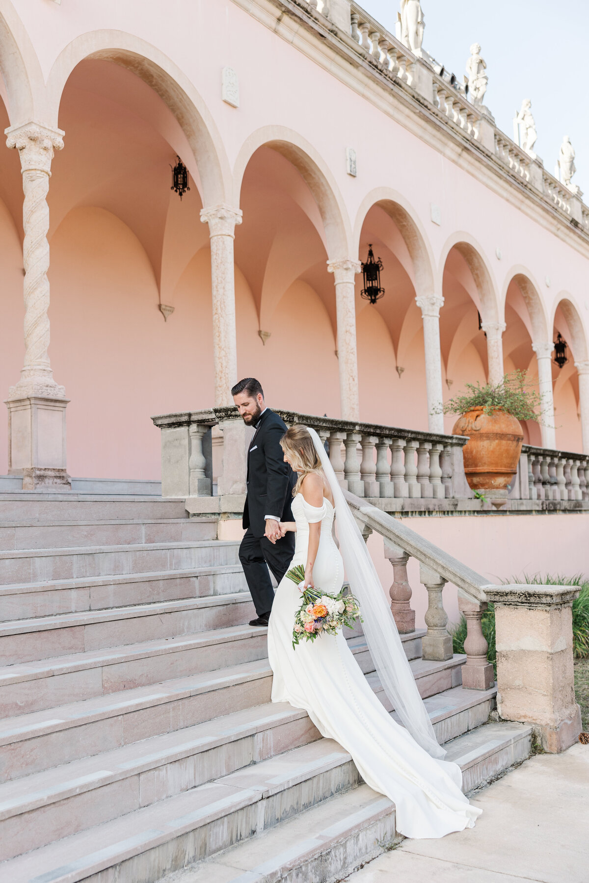 bride and groom walking up the stairs at the ringling