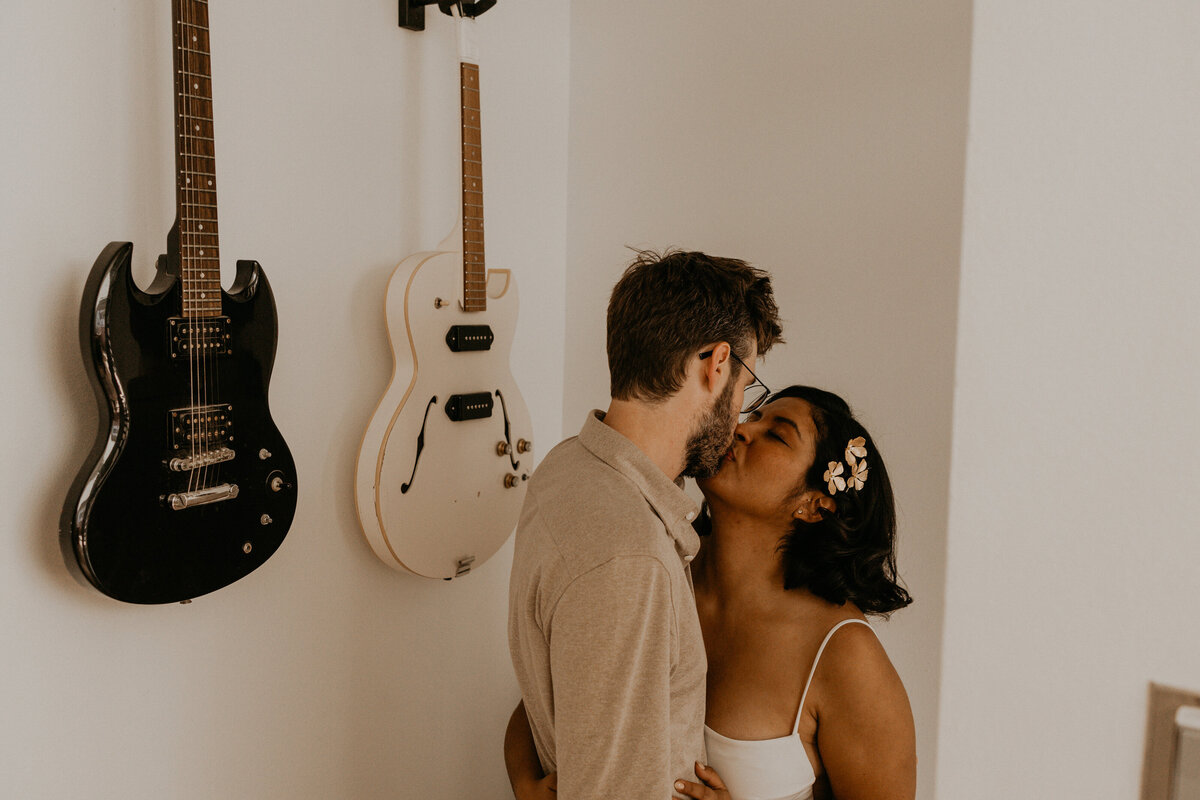 bride an groom kissing in a modern apartment