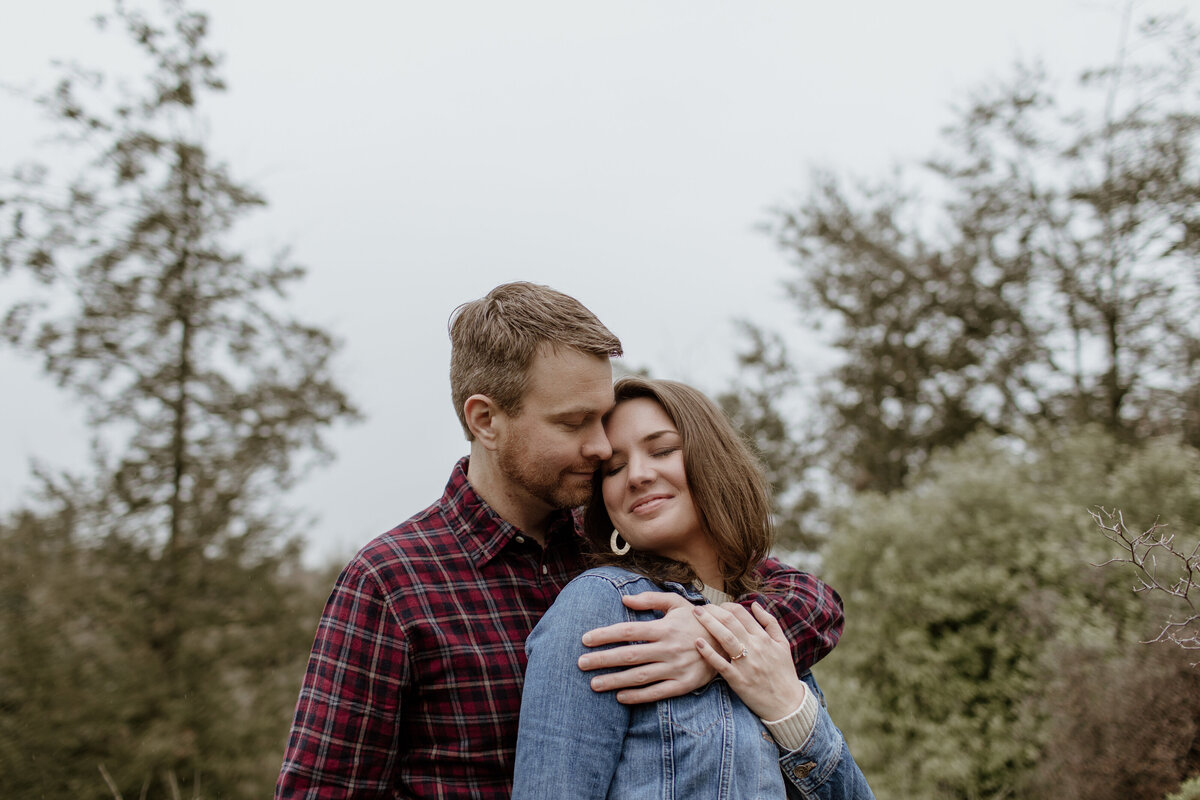 A cozy and romantic moment of an engaged couple captured by Fort Worth Wedding Photographer, Megan Christine Studio