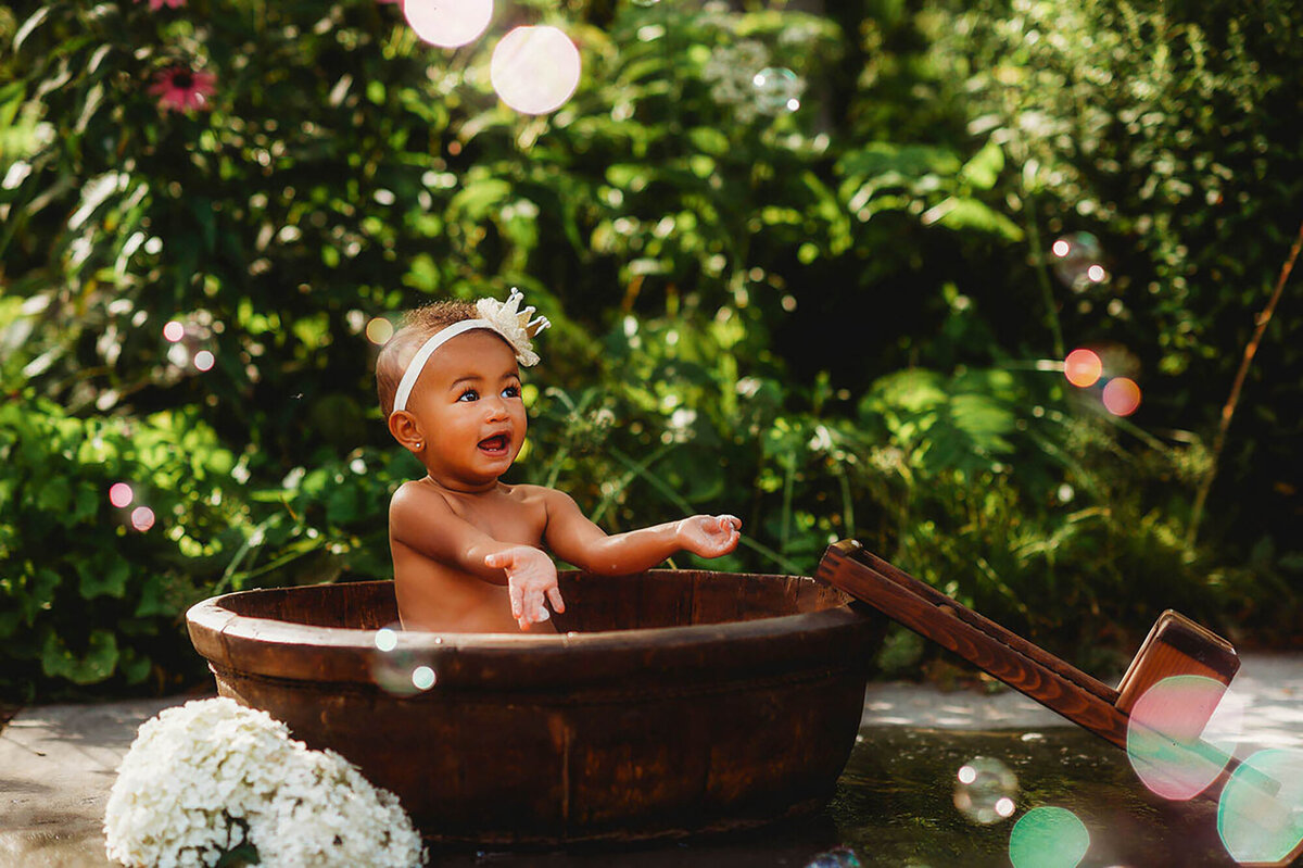 Little girl poses for portraits during Family Photoshoot at the NC Arboretum in Asheville, NC.