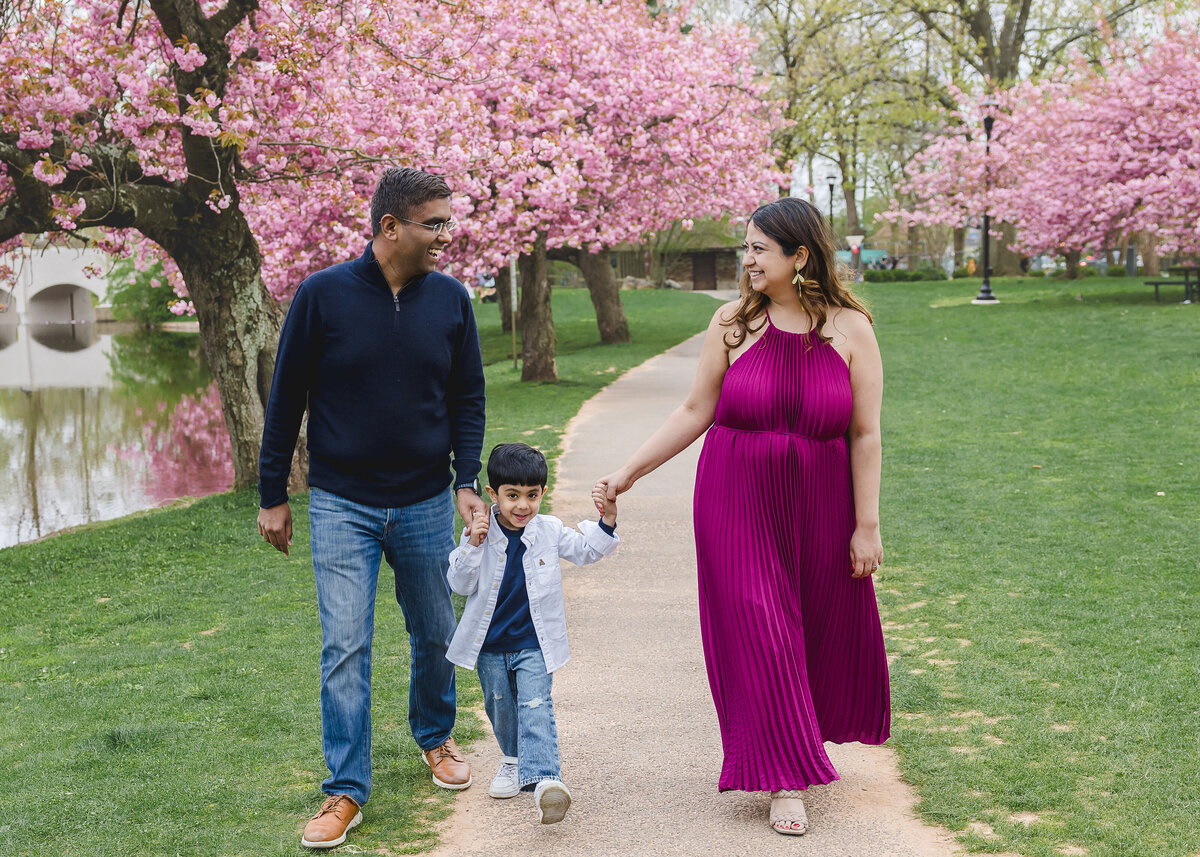Lifestyle photo of family walking and holding hands at an Essex County, New Jersey park.