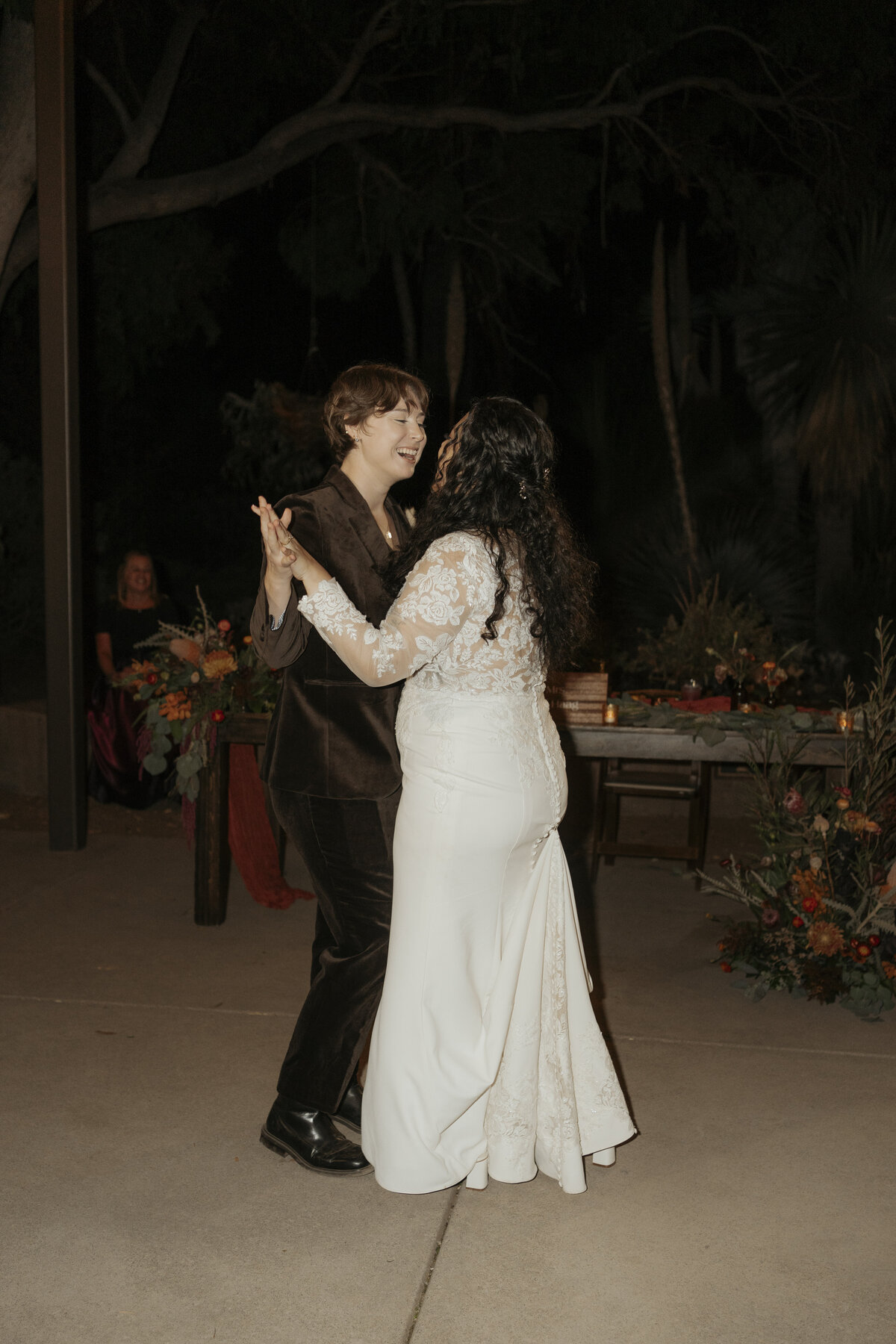 Same sex couple shares their first dance at their reception venue, Ruth Bancroft Botanical Garden