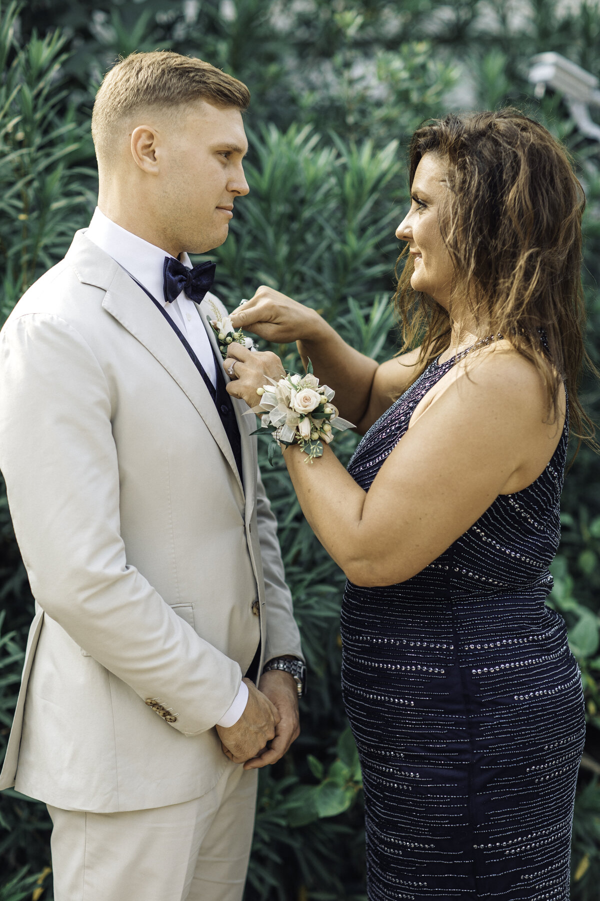Wedding Photograph Of Woman Fixing Groom's Corsage Los Angeles