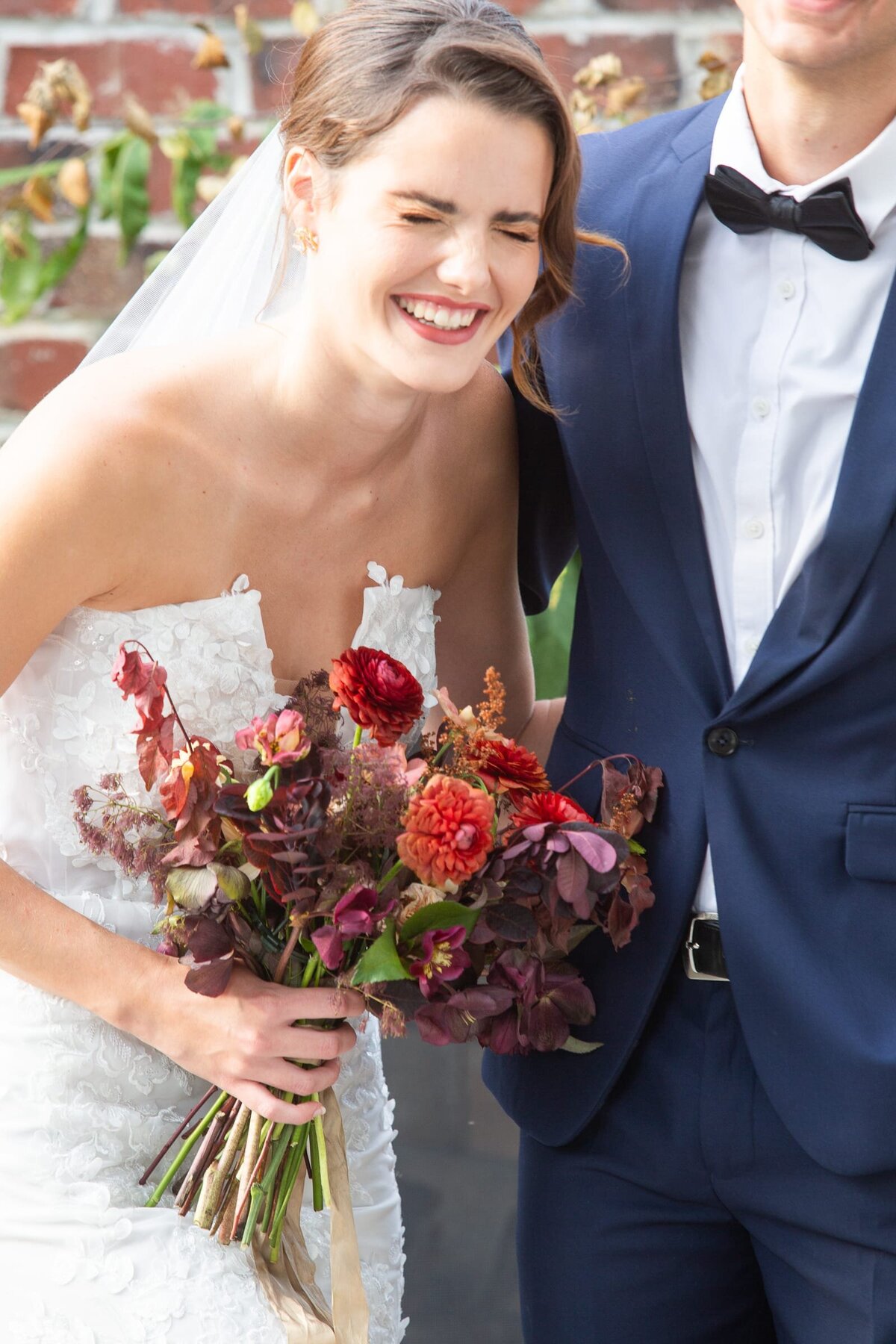 bride-laughing-red-flowers