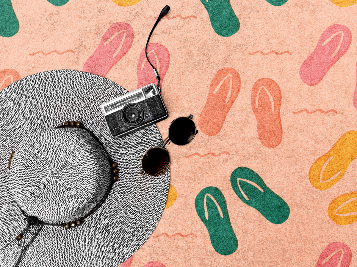 hat-on-a-towel-template-with-sunglasses-and-a-camera-lying-on-it-a14901