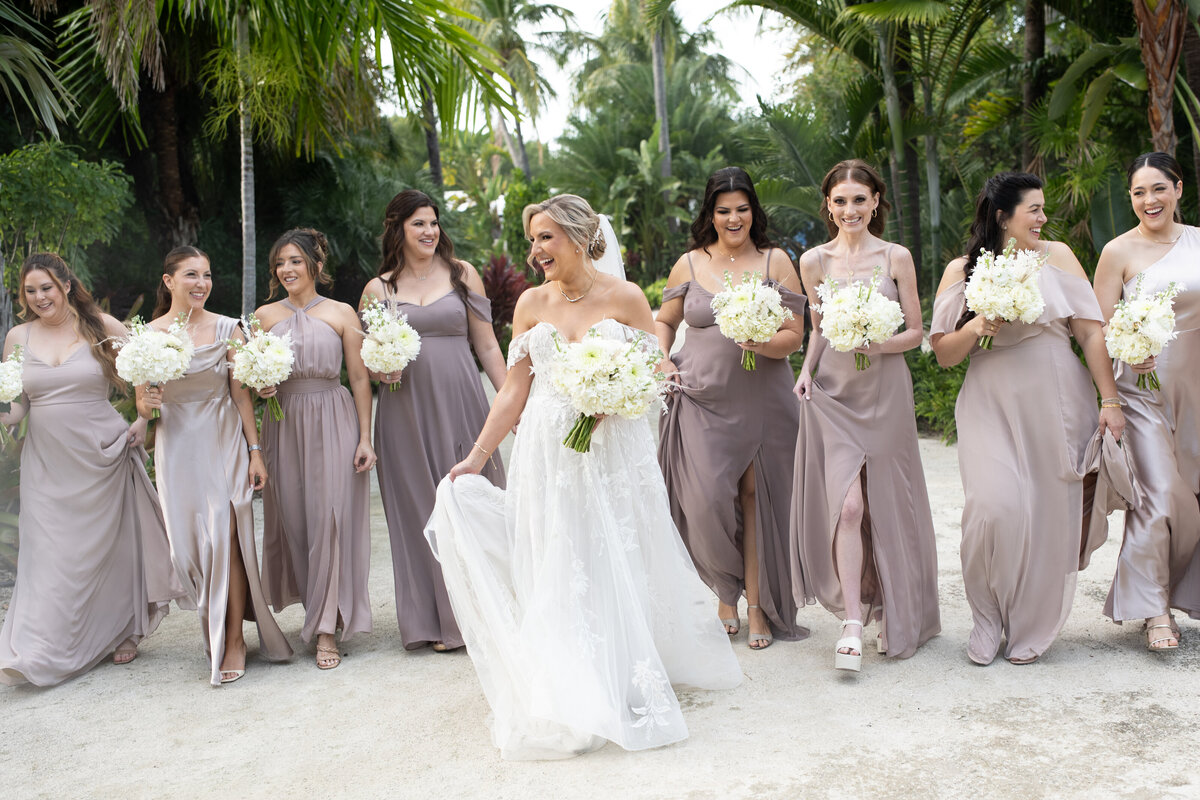 Bride walking with bridesmaids on Naples beach