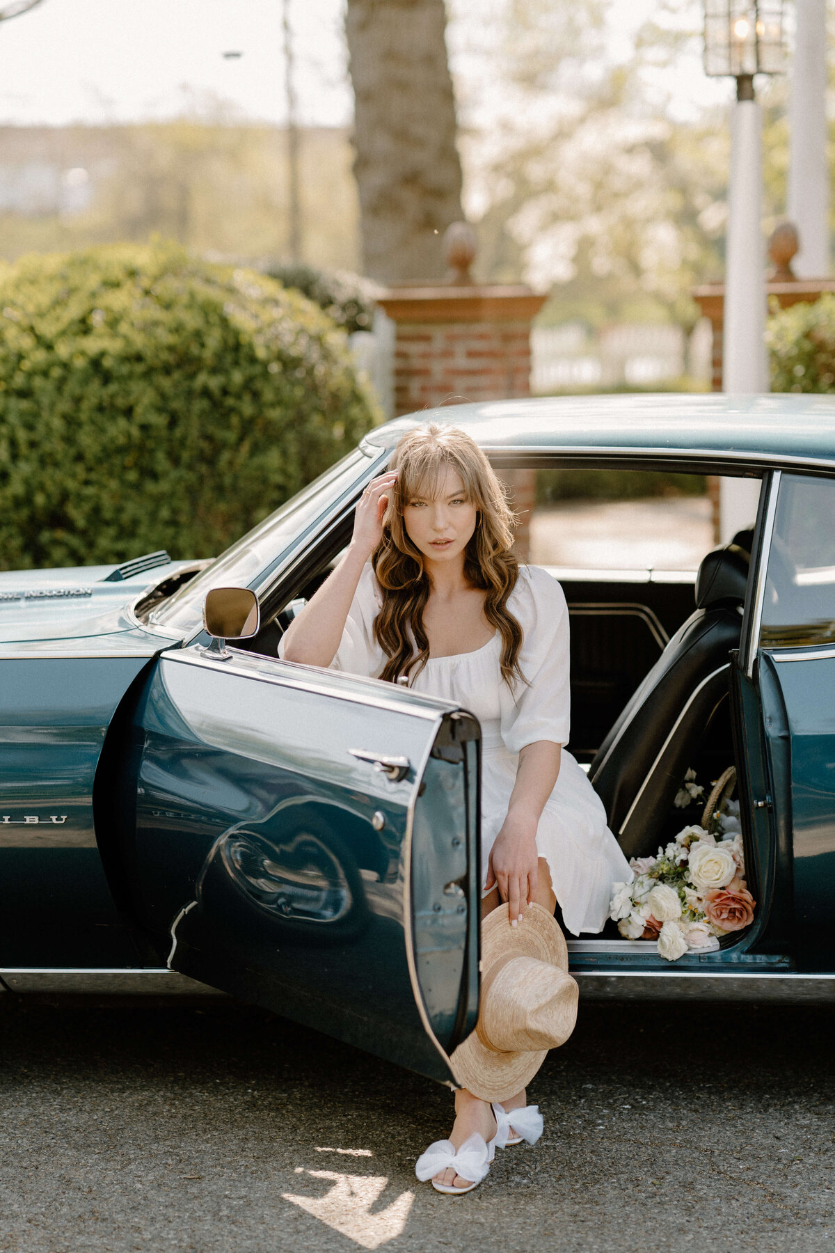 bride sitting in vintage car