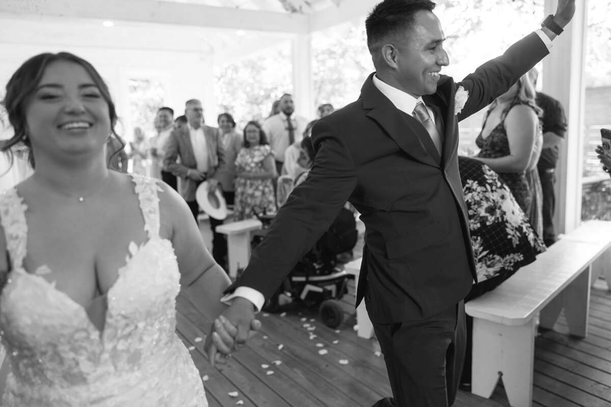 Candid photo of a bride and groom holding hands during their Colorado mountain wedding near Denver.”