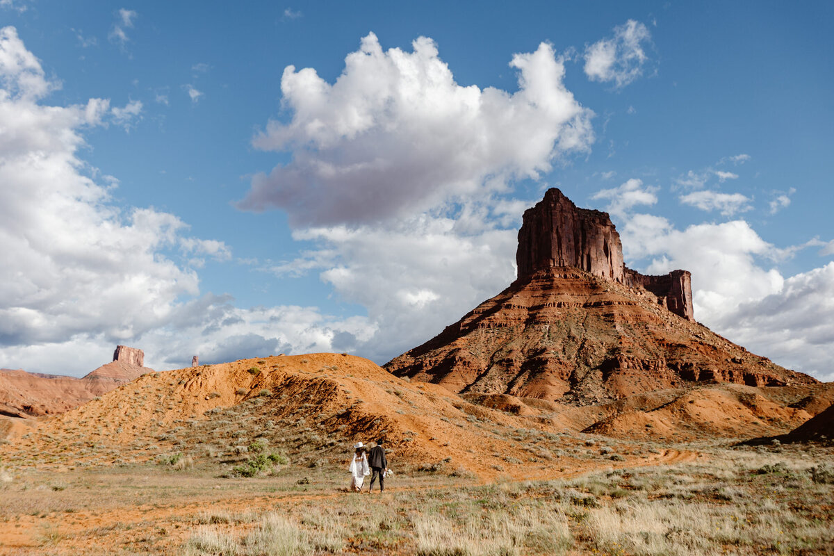  A bride and groom make their way to their ceremony spot at Ida Gulch in Moab. 