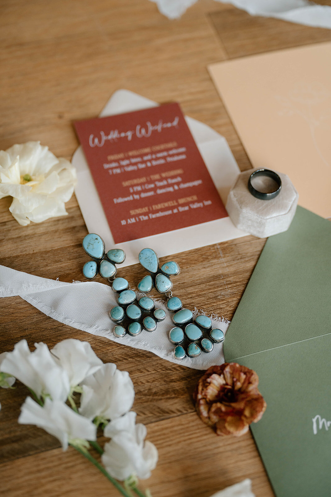burnt-orange-invite-flatlay-blue-rings