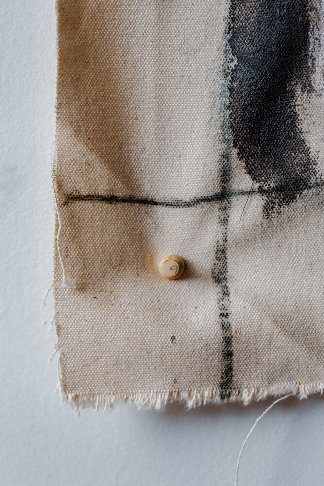 a close up image of a thumbtack in a canvas