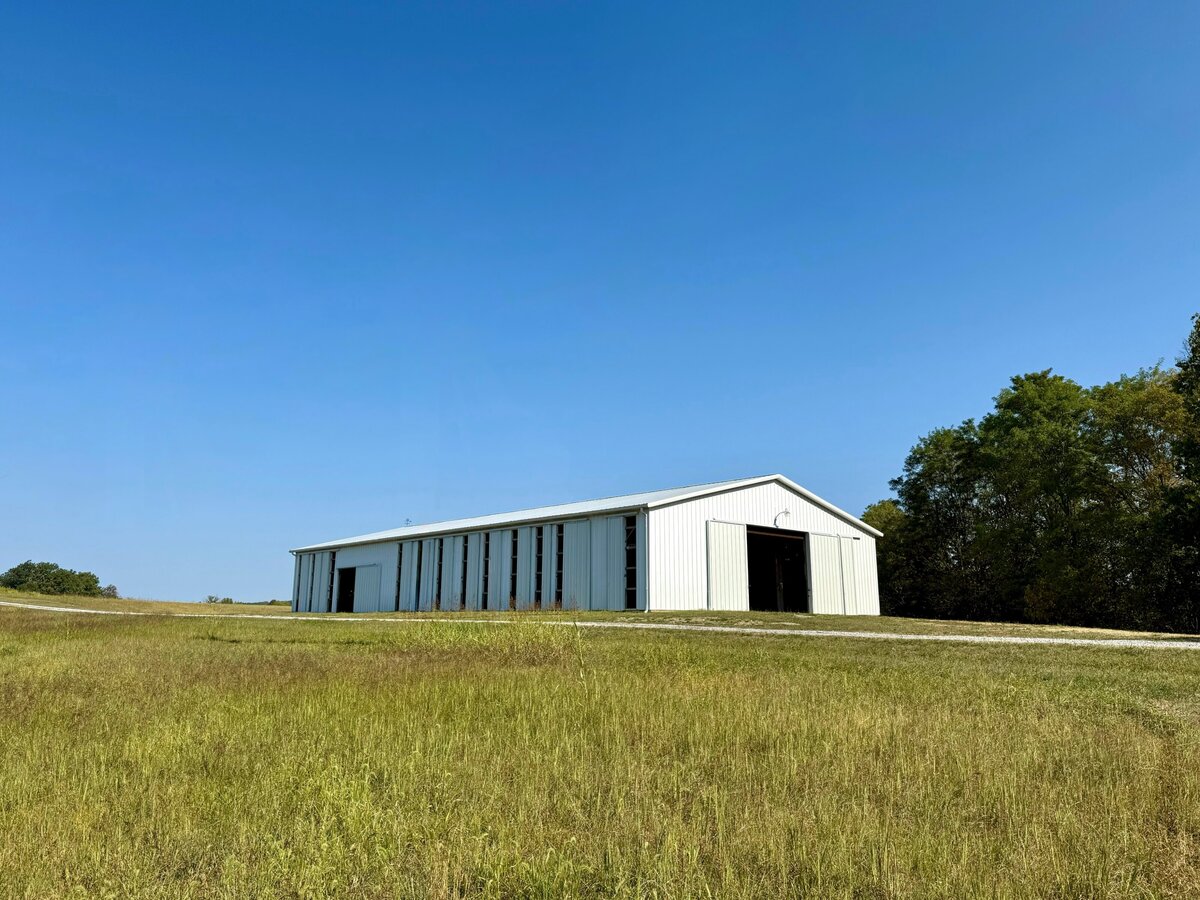 Reception barn at Willstone Acres Central Kentucky wedding venue with bluegrass fields in front