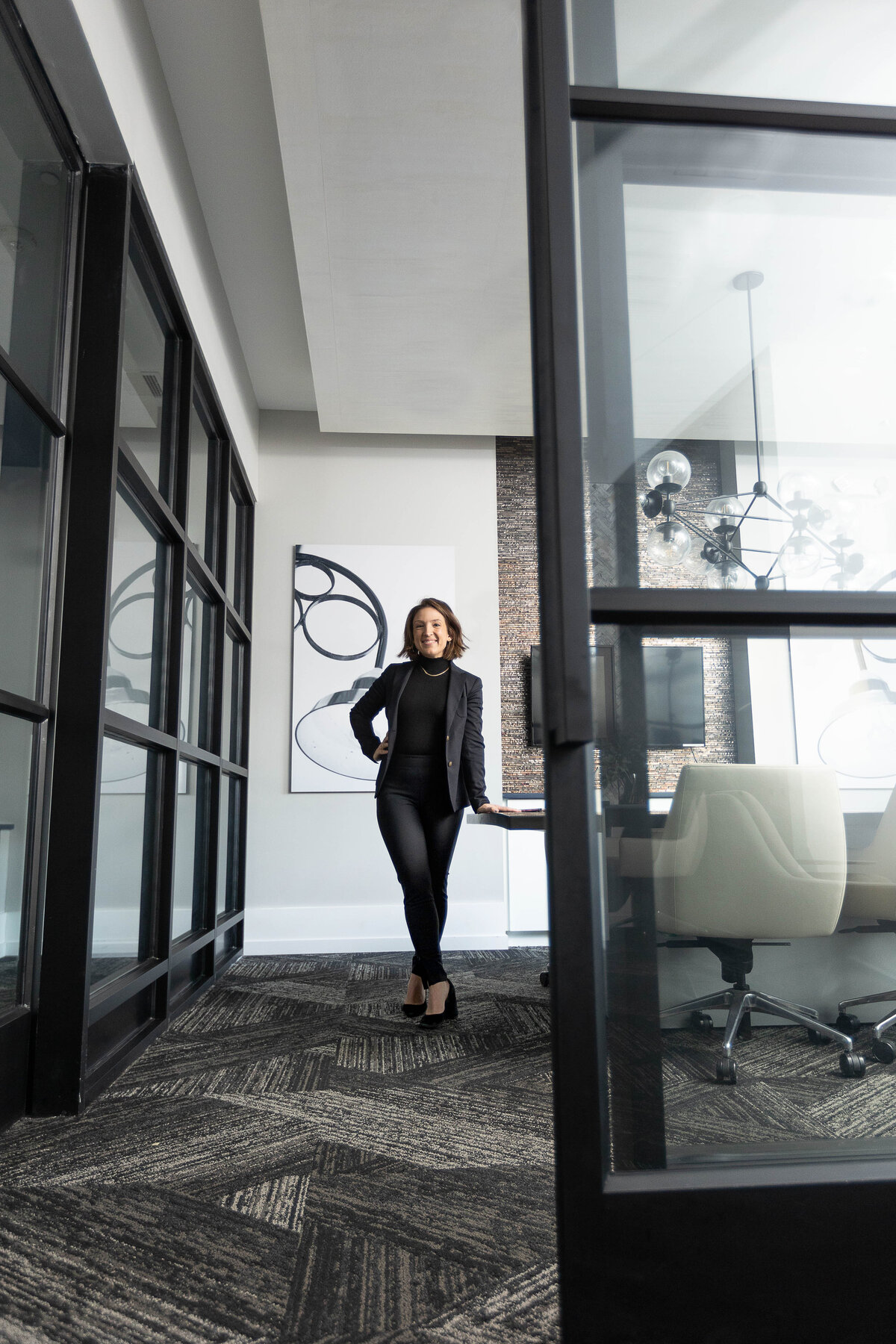 woman in power pose in a conference room