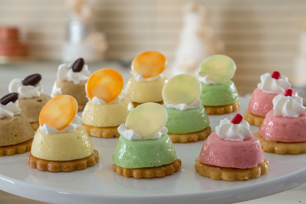 Assorted mini mousse cakes with fruit toppers