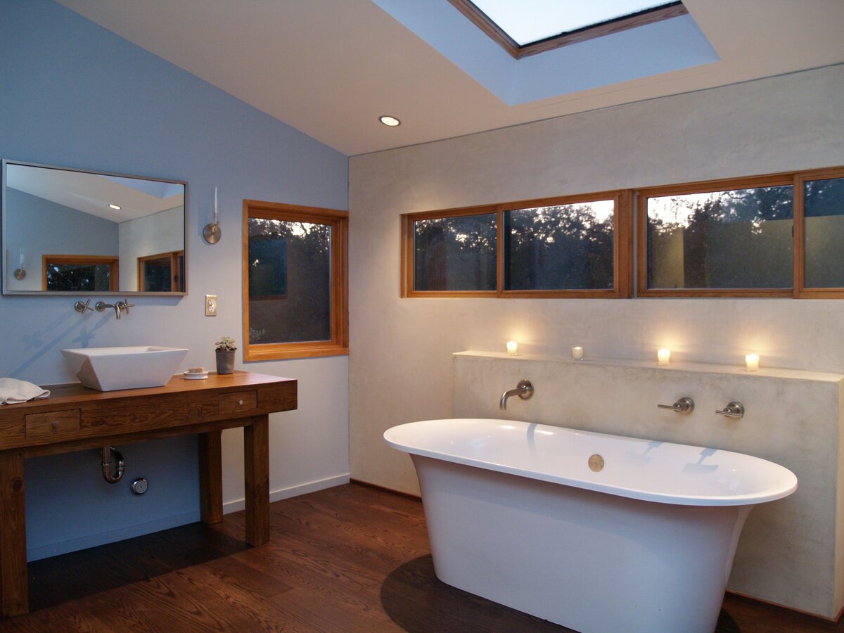 soft lighting in restroom, stand-alone bath tub with sky light in bathroom.
