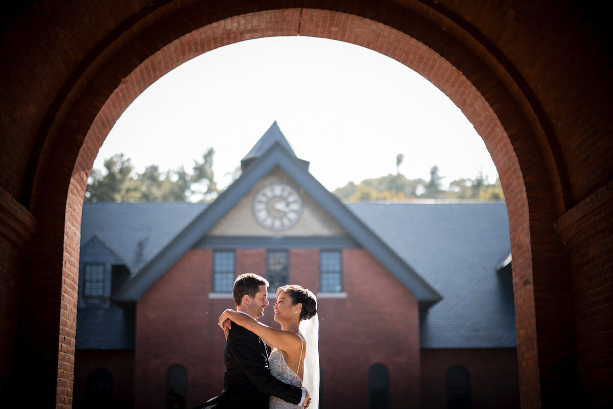 A bride and groom pose for photos at a destination wedding in Vermont