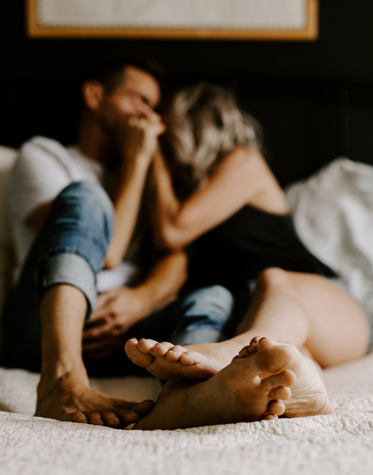 Couple poses for a cozy in-home engagement photoshoot