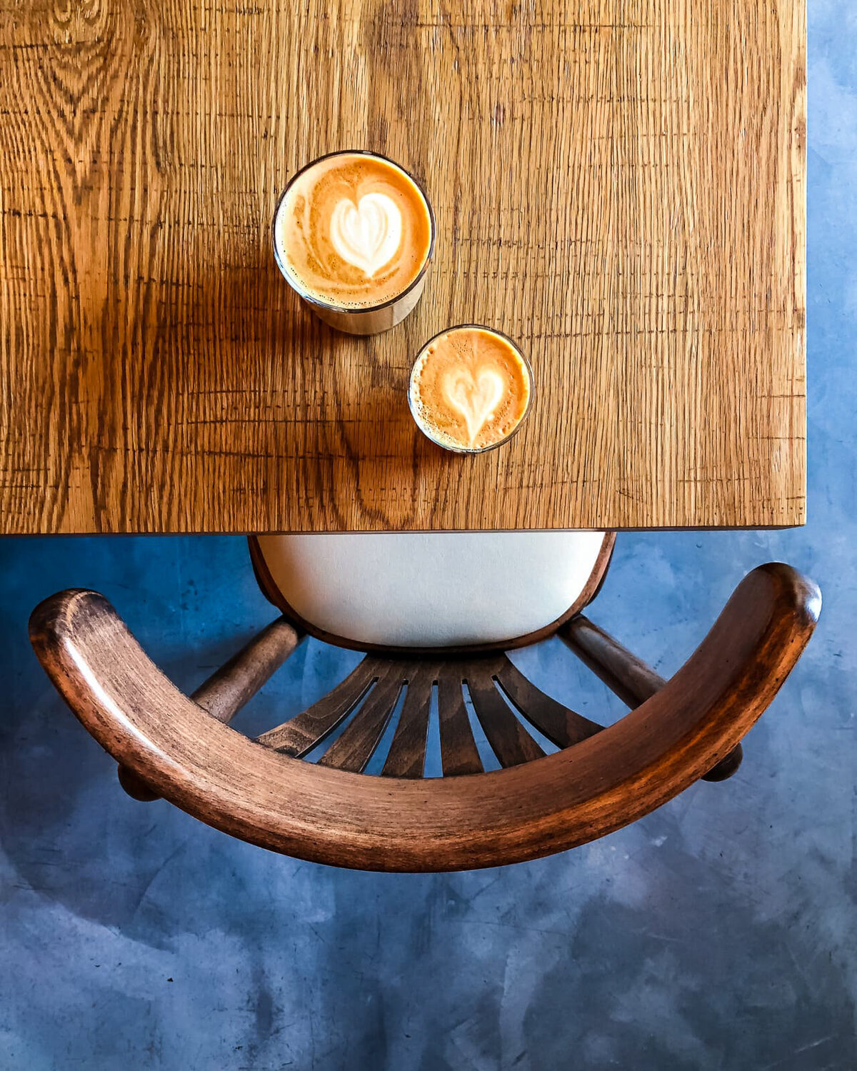 02.-Coffee-Latte-Art-on-wood-table-chair-and-floor-Izu-Brasserie