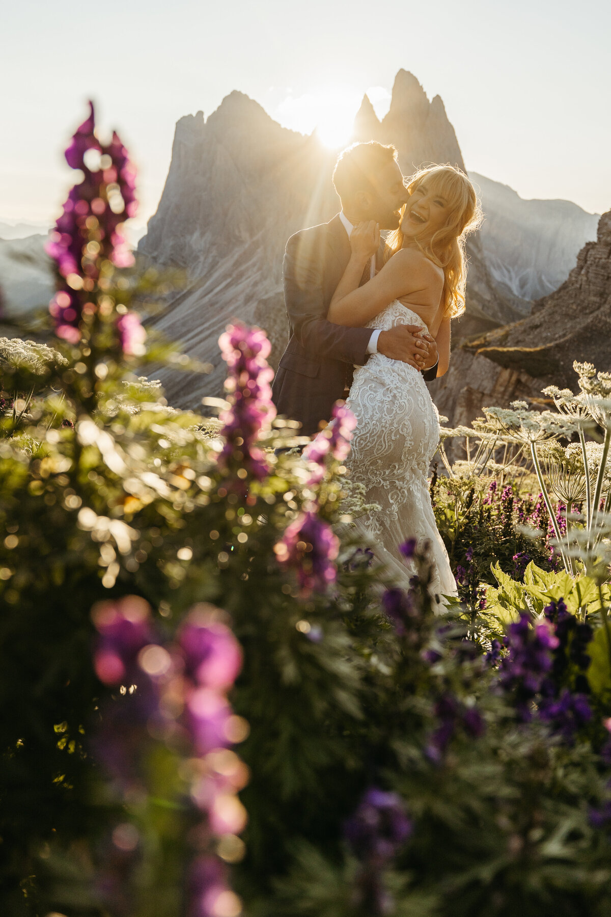 Couple hugging in alpine meadow at sunrise Seceda