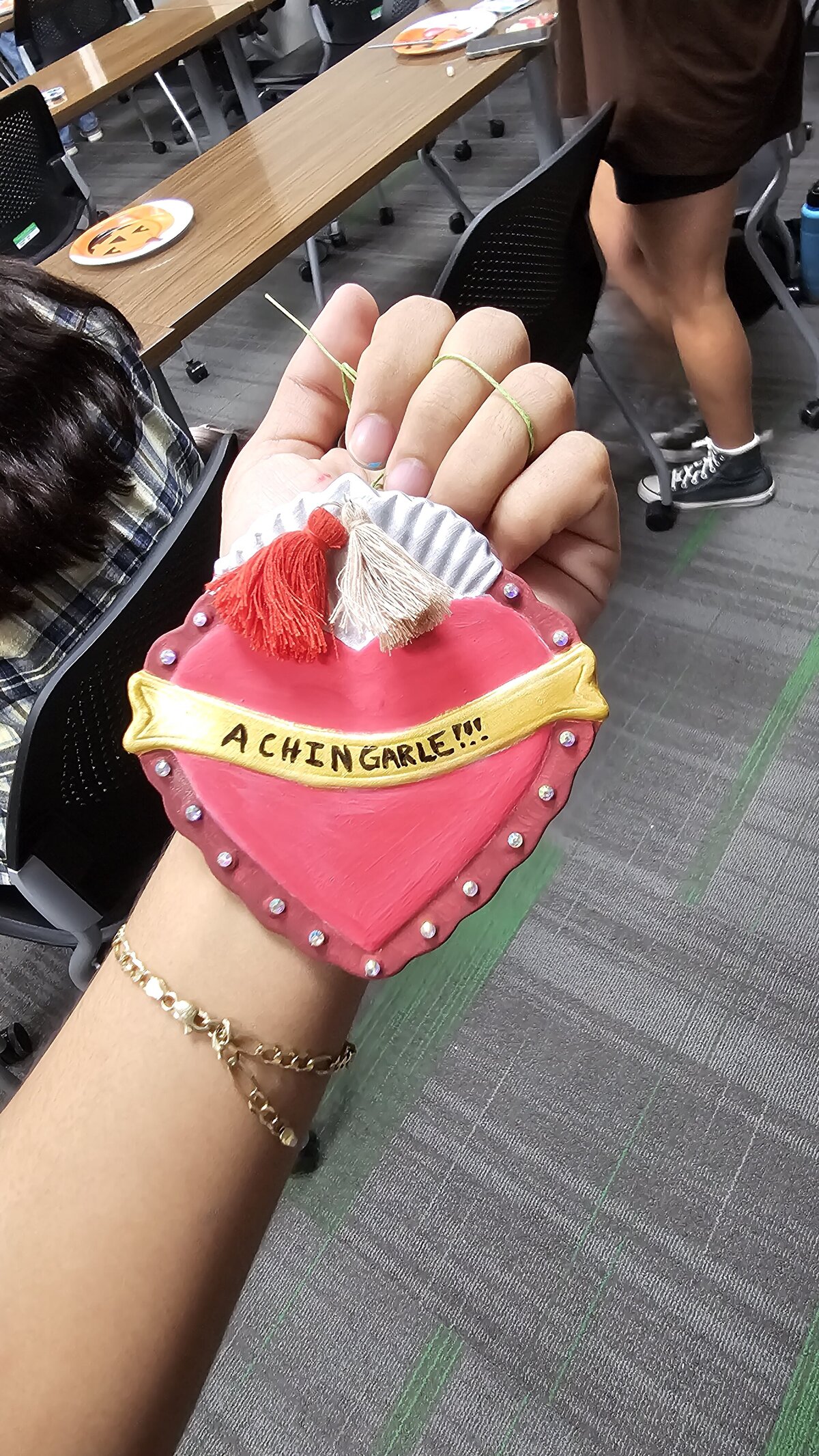 The artistic triumph as a workshop participant proudly presents their final masterpiece—a colorful heart adorned with an inspirational phrase. Tthe materials that brought this creation to life at Soleil Vida Studio.