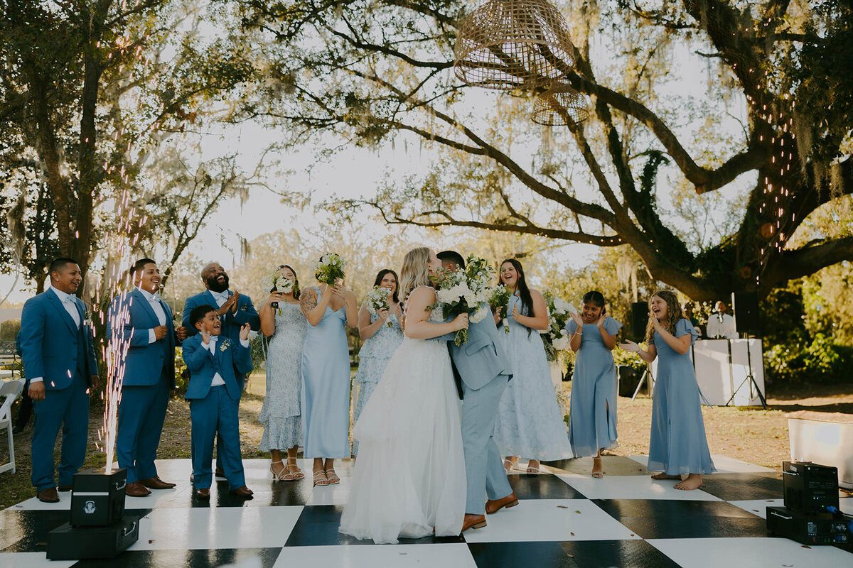 Wedding party laughing under oak trees at Uliana Estate in Lakeland Florida.

