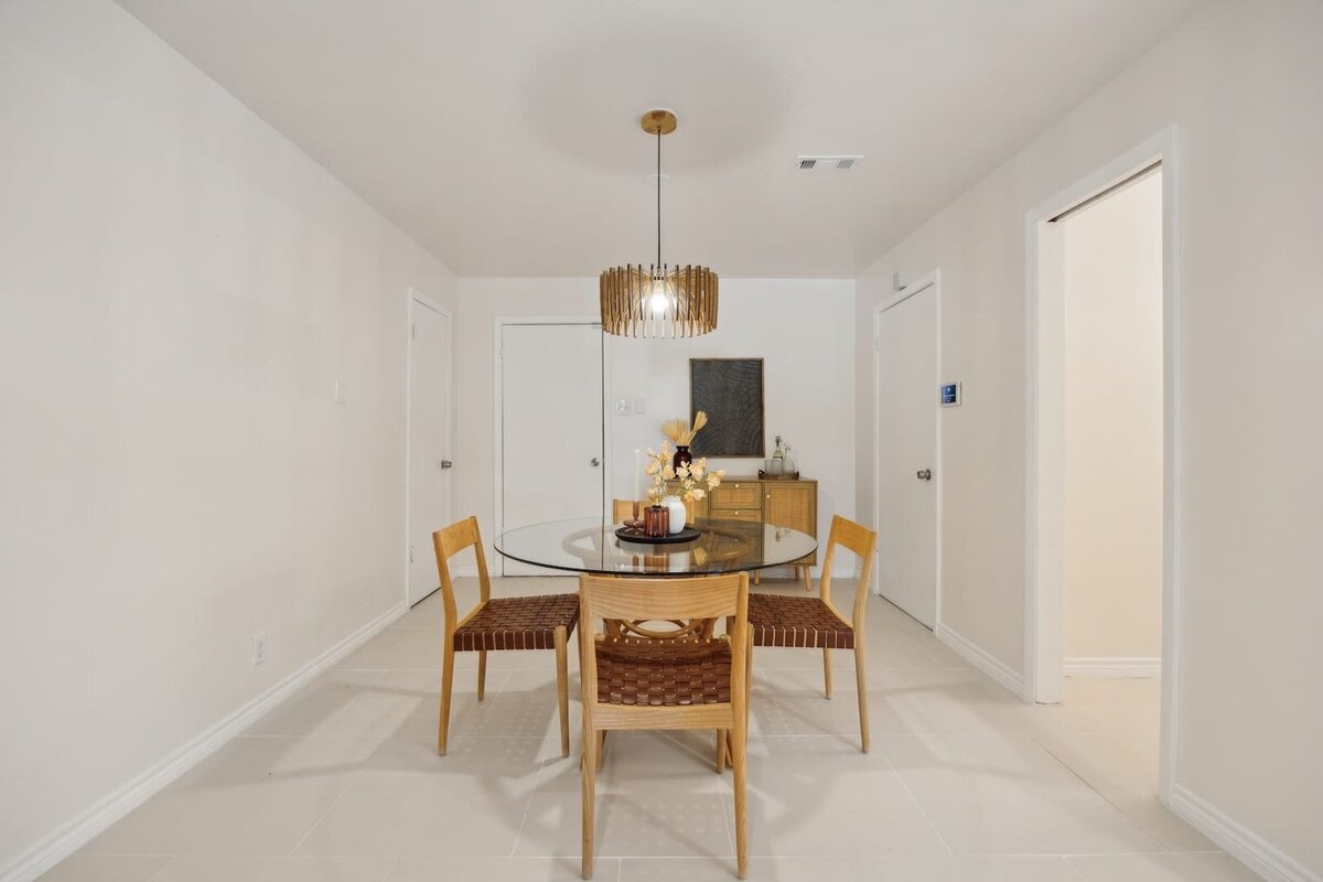 Cozy breakfast nook at 3120 Chapel Downs Dr Dallas TX featuring midcentury modern furniture, pendant light fixture, and tile flooring — listed by Haven Realty Group.