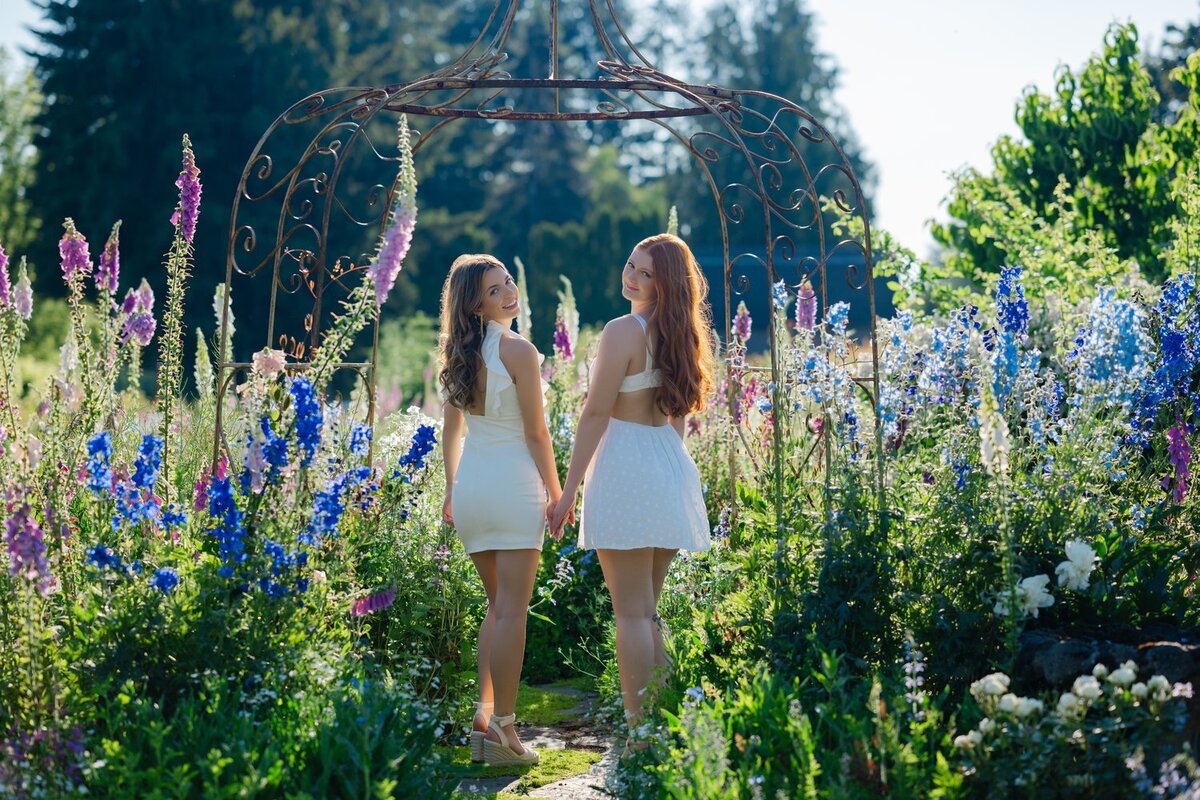scattered seeds flower farm graduation portraits white dresses two girls