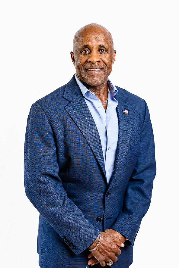 Man in blue jacket and white background.
