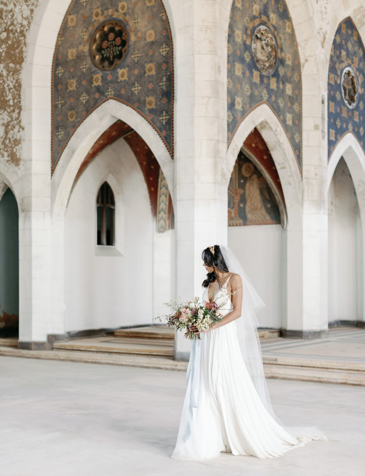 bride under crumbling arches, abandoned cathedral, ancient wedding venue