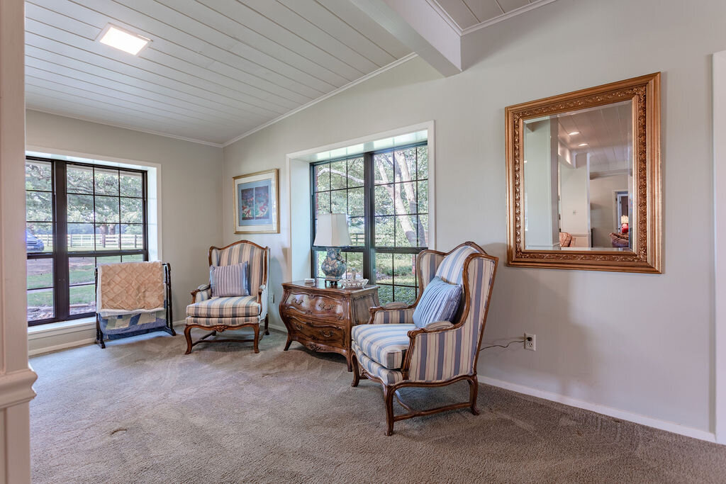Sitting room with comfortable seating in this 5-bedroom, 4-bathroom vacation rental house for 16+ guests with pool, free wifi, guesthouse and game room just 20 minutes away from downtown Waco, TX.