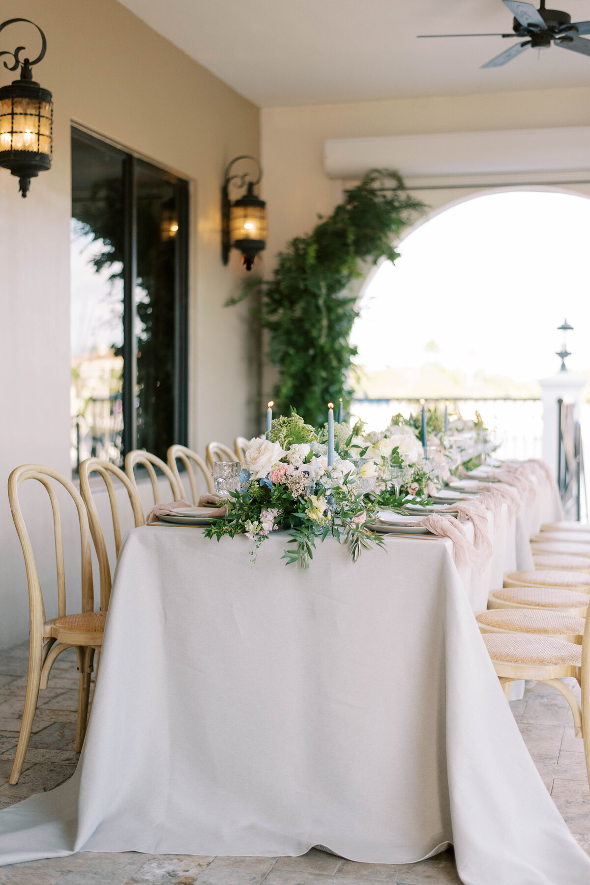wedding table with greenery filled centerpieces