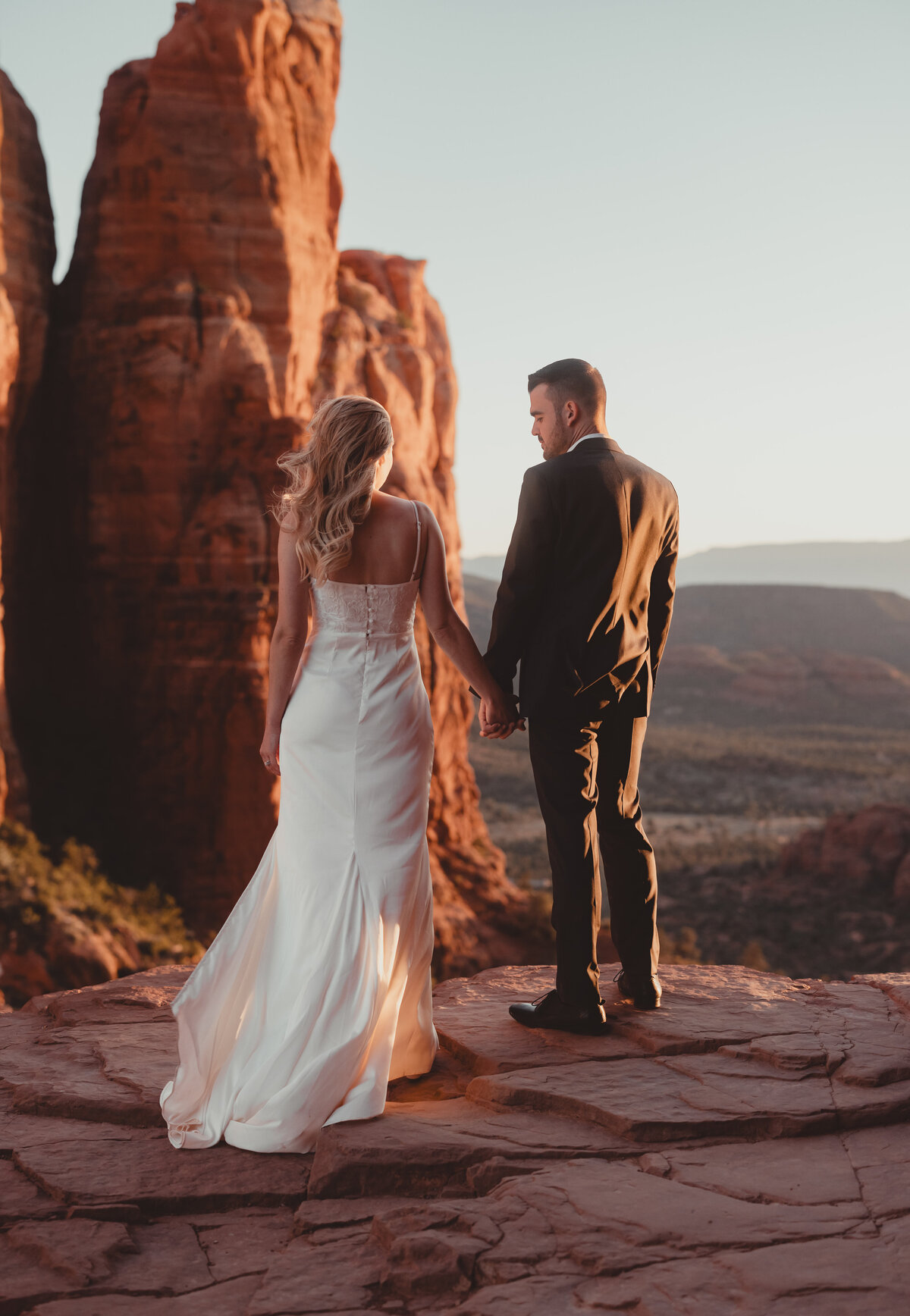 Bride and groom hiking Cathedral Rock trail in Sedona taken by Kollar Photography