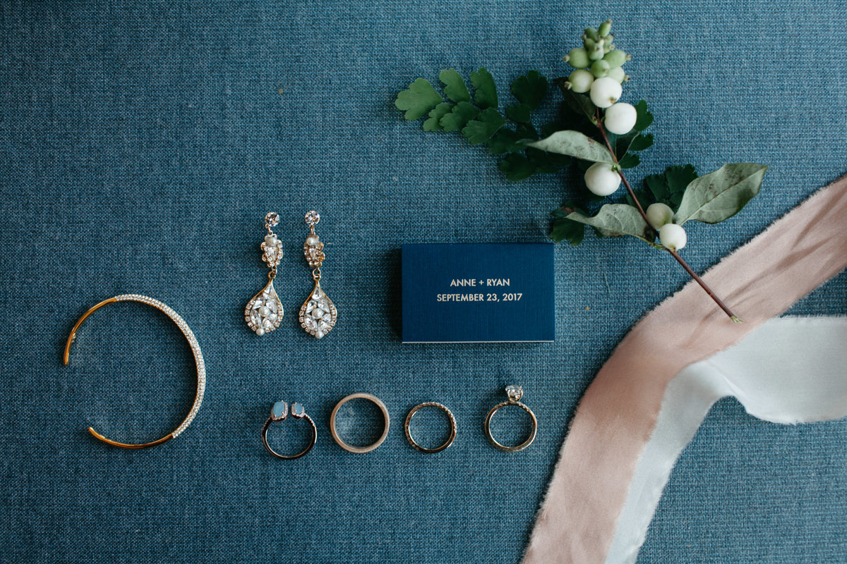 Wedding jewelry on blue velvet with peach ribbon