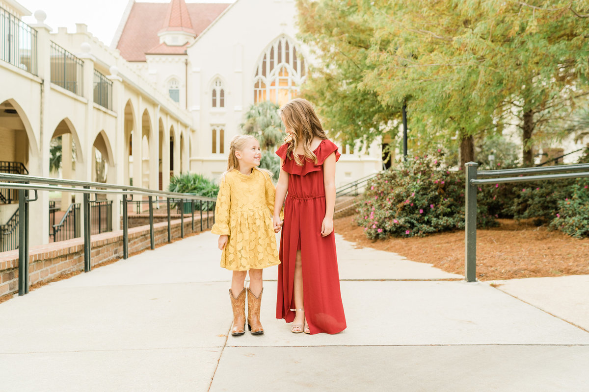 Girls in yellow and red dresses in park in Alabama