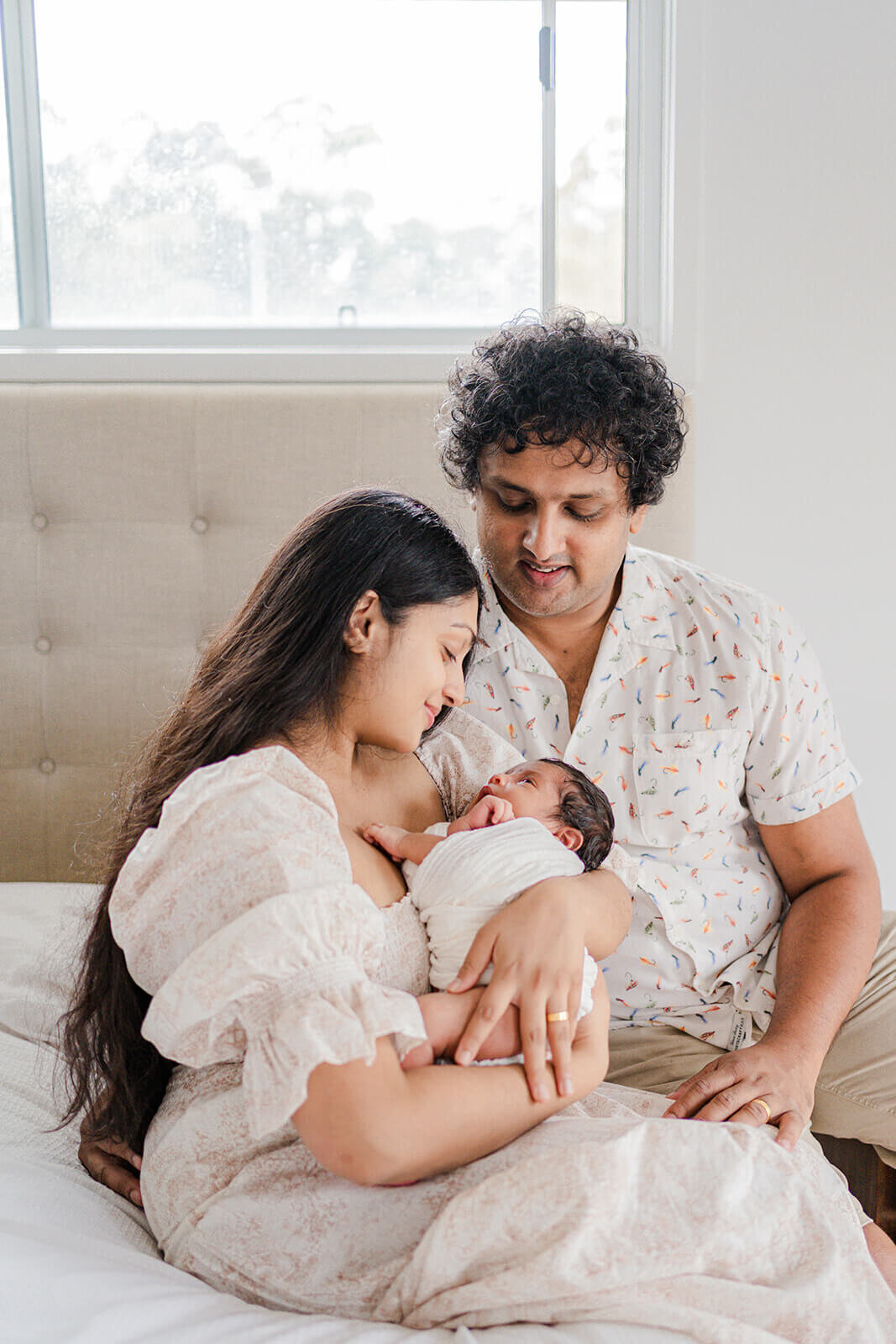 Capture precious moments: mum, dad and newborn in Gold Coast in-home session as part of their newborn maternity portrait package.