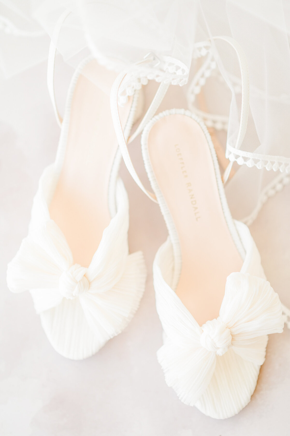 Detail photo of white Loeffler Randall wedding shoes.