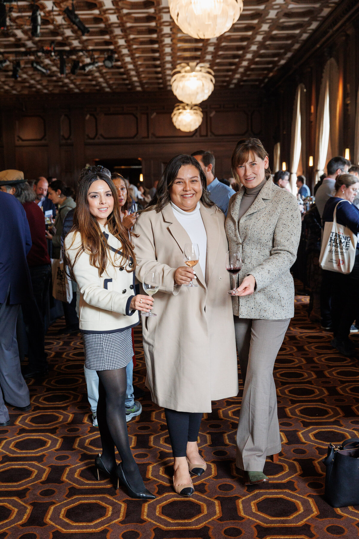 Three females in a wine convention